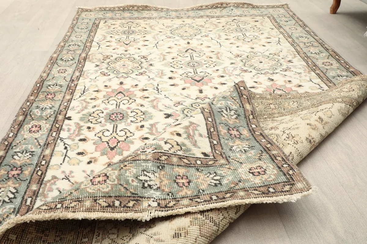 The vintage rug folded to show the thickness and texture of the wool pile