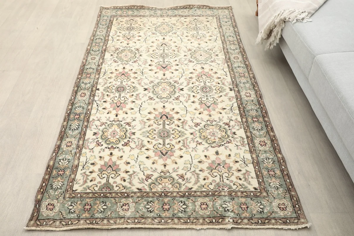 Overhead view of the ivory and green vintage rug in a room setting