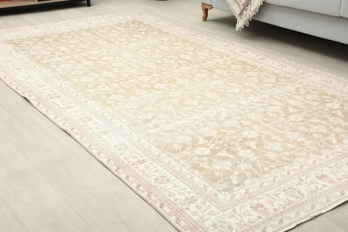 Close-up room view of the vintage rug, showing its placement relative to furniture