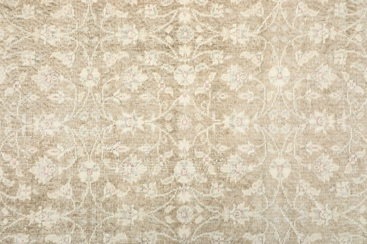 Detailed close-up of the rug's field pattern, showing the intricate floral motifs and texture
