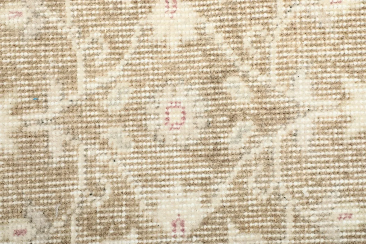 Close-up of the low wool pile, revealing the hand-knotted texture and color depth