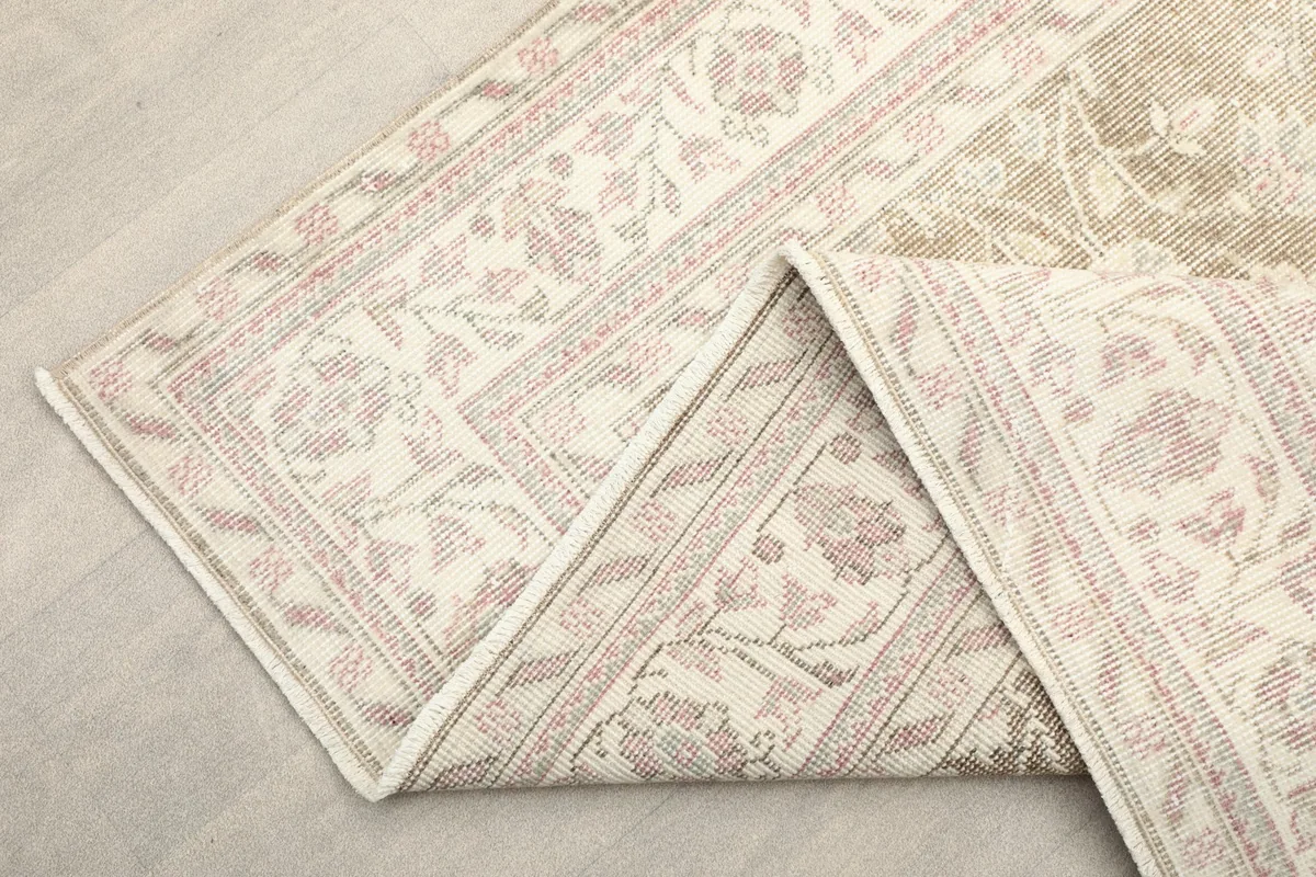 Another view of the folded rug corner, emphasizing the border design and construction