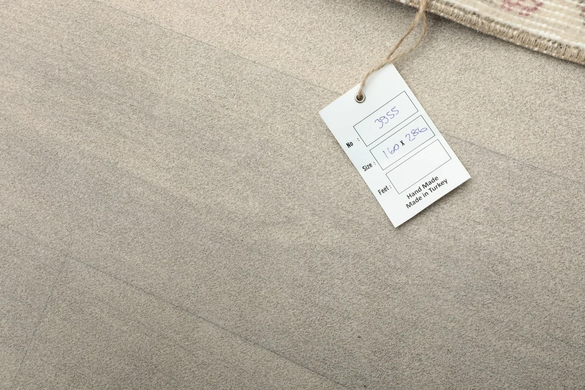 Close-up of the product tag, indicating 'Hand Made in Turkey' and rug dimensions