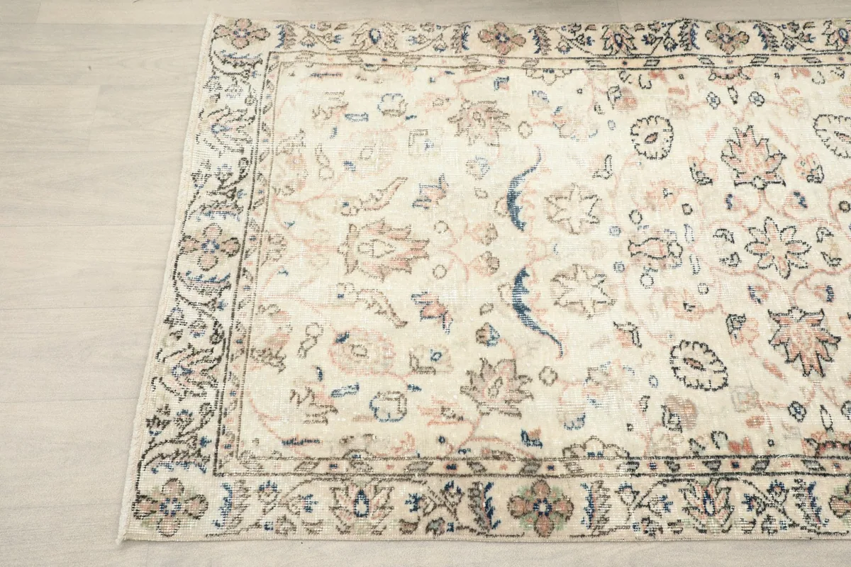 Angled view highlighting the intricate floral patterns and the contrasting navy border