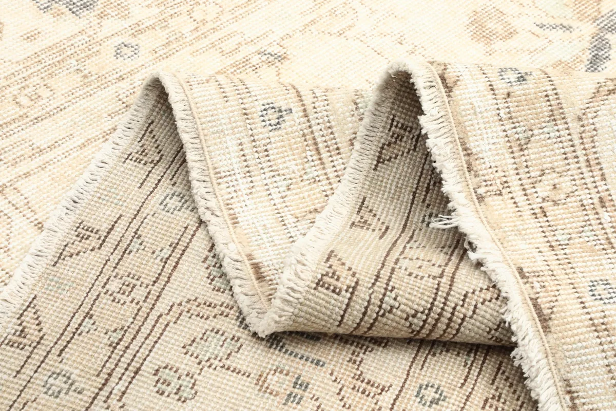 Folded rug showing the texture of the back and the tightly woven cotton foundation.