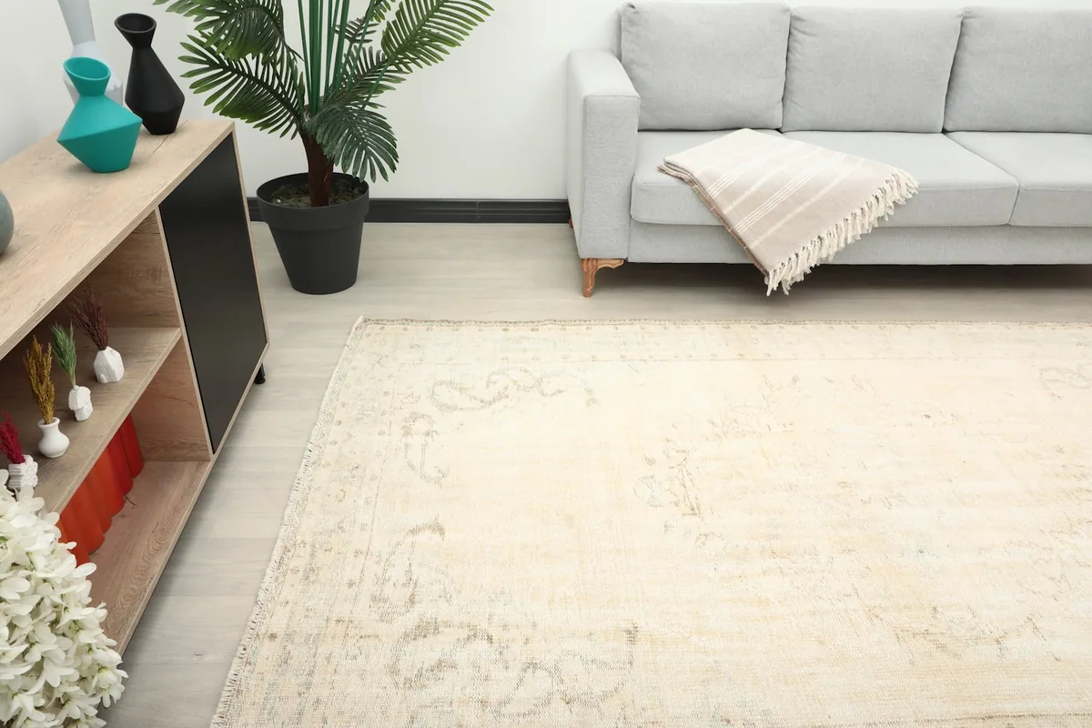 Partial view of the rug extending from under a gray sofa in a modern living space