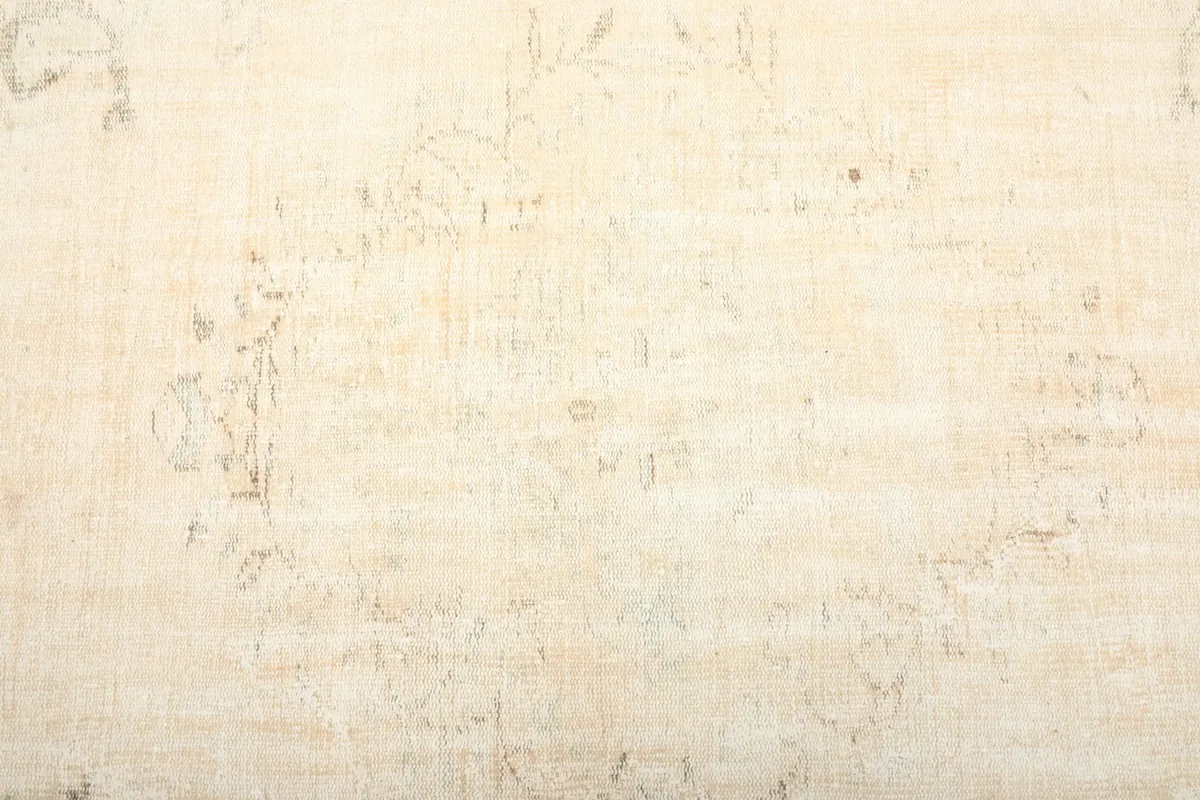 Close-up of the central field, highlighting the faded geometric design and natural patina