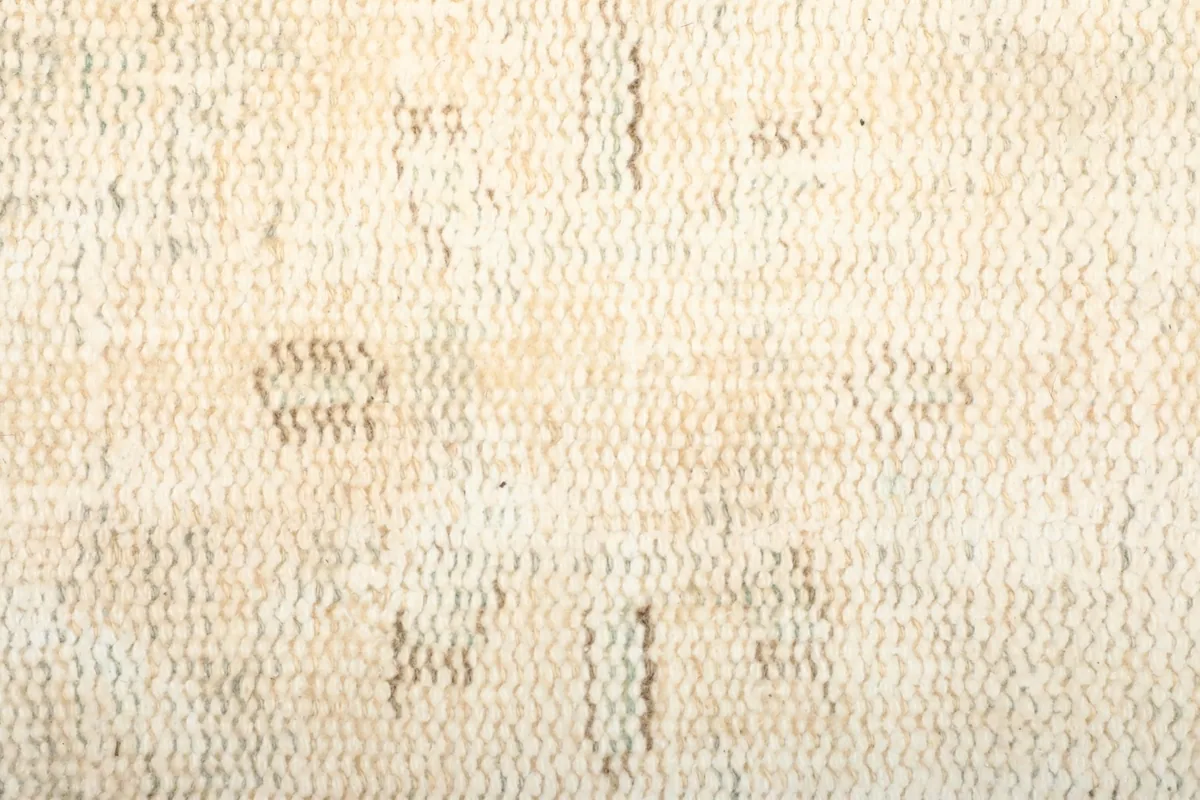 Texture shot of the low wool pile, showing the hand-knotted weave and subtle color variations