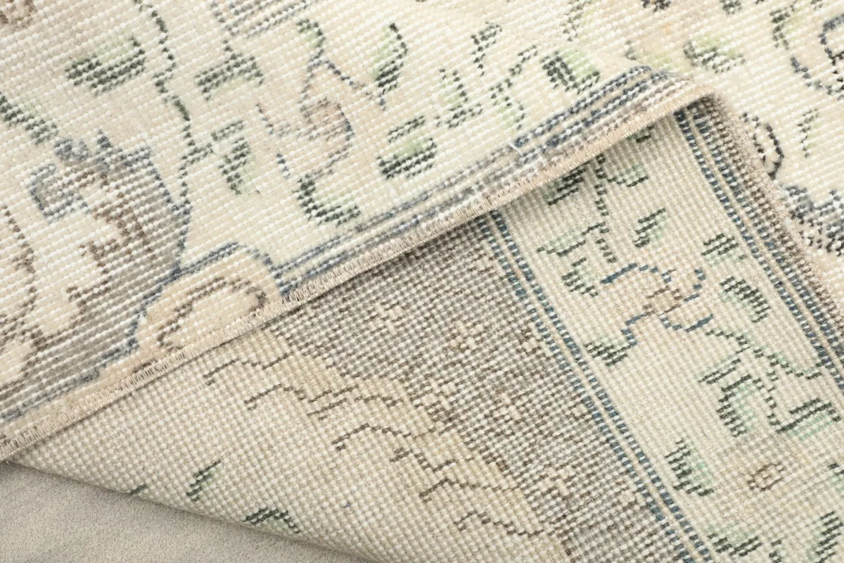 Close-up of the back of the rug, showcasing the tight hand-knotting and cotton foundation.