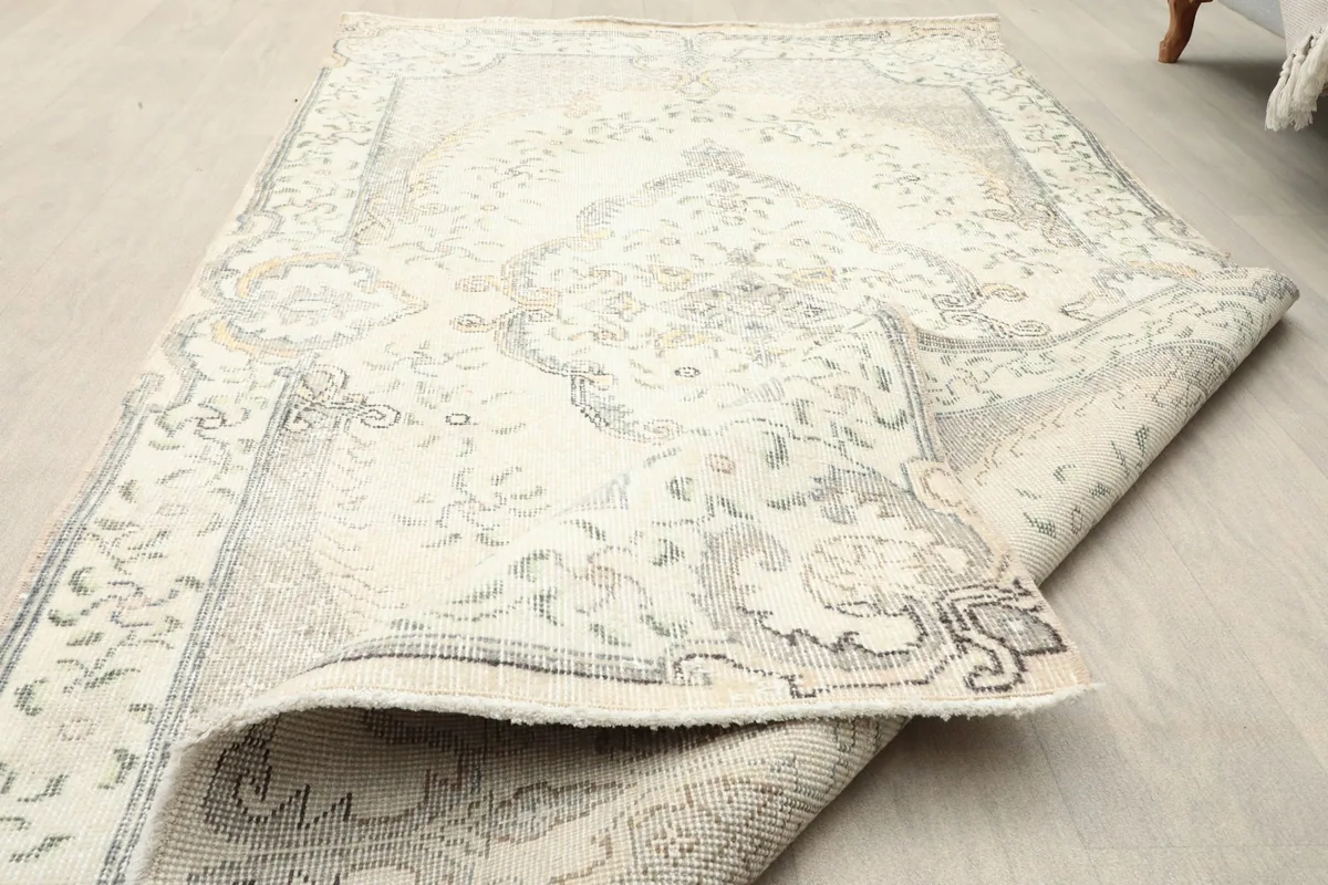 View of the rug with a corner folded over, illustrating its flexibility and construction.