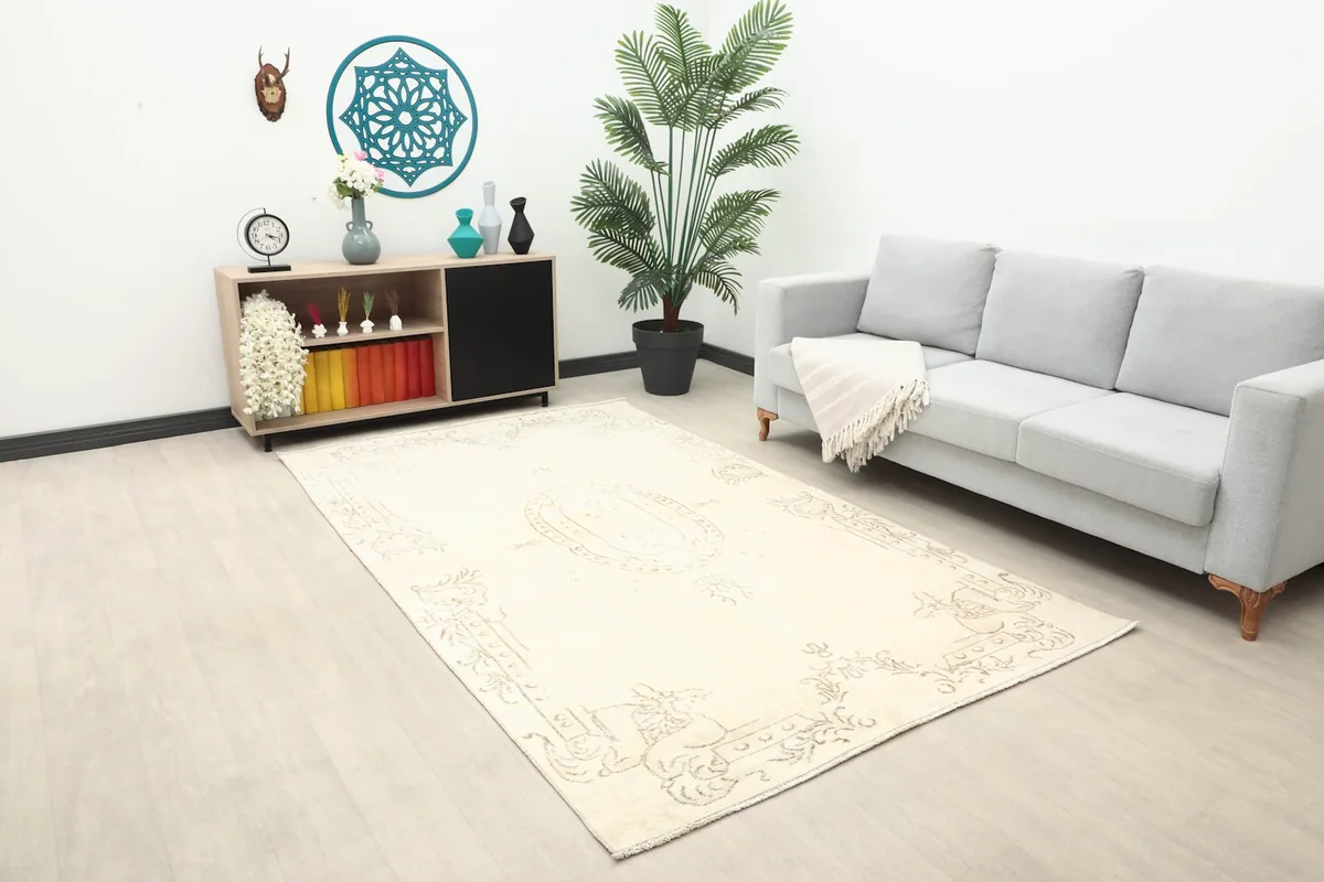Wide shot of the cream Anatolian rug in a modern living space with light-colored flooring.