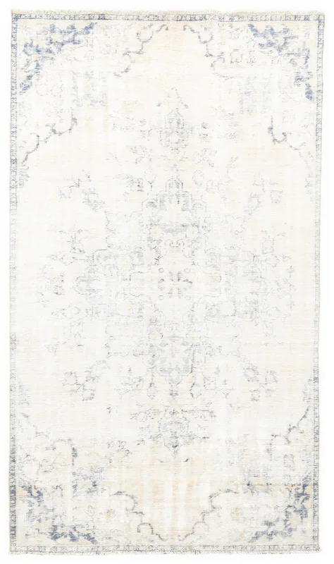 Full top view of the ivory and blue vintage Anatolian rug on a white background