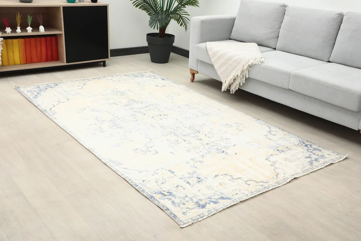 Angled view of the ivory and blue rug complementing modern furniture in a room