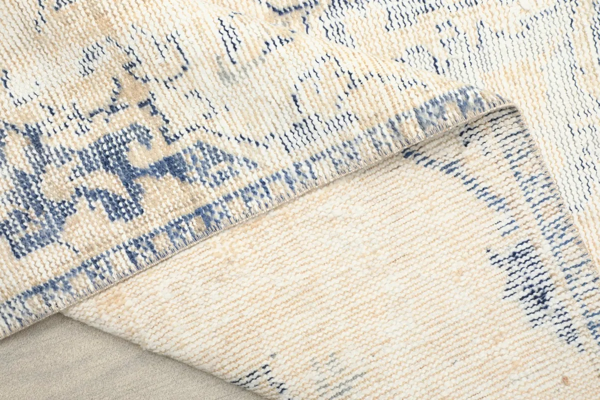 Underside view of the hand-knotted cotton foundation and reverse side of the wool pile