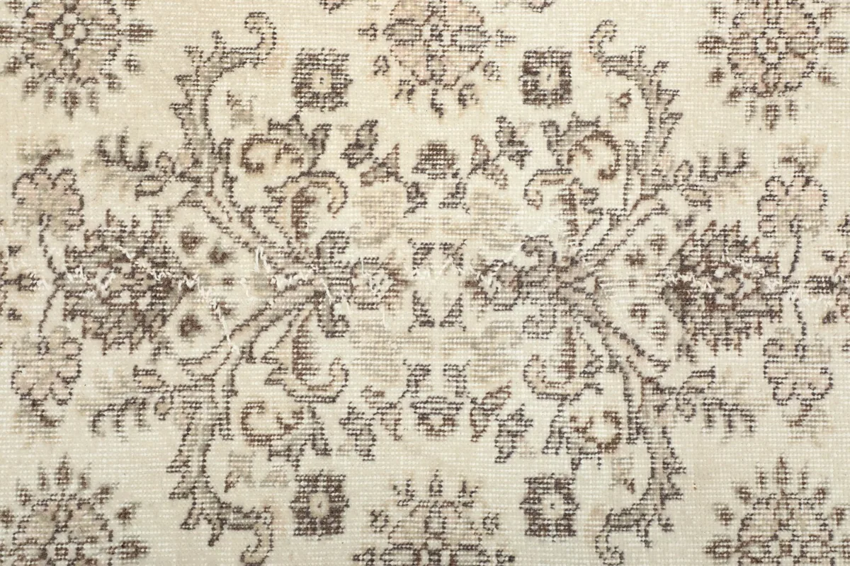 Very close-up of the rug's central design, revealing the intricate patterns and low pile.