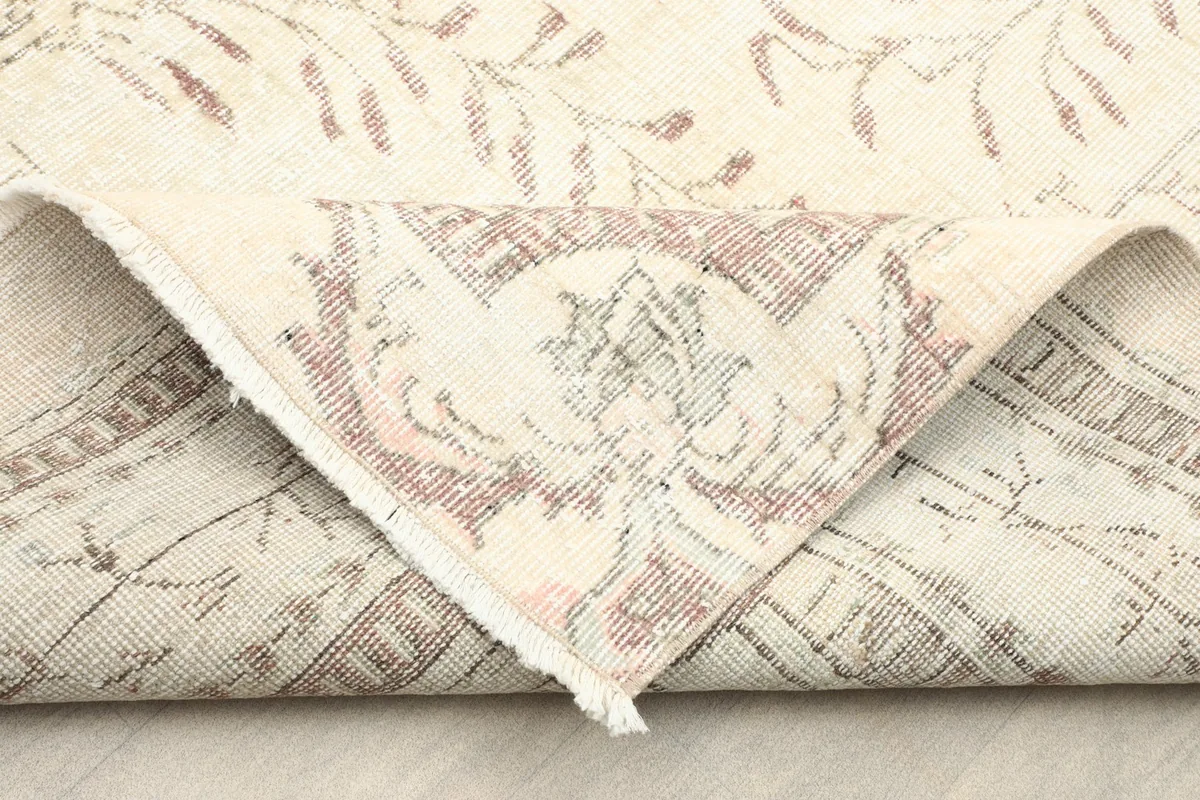 Folded corner of the rug, showing the reverse side and the tight hand-knotted construction