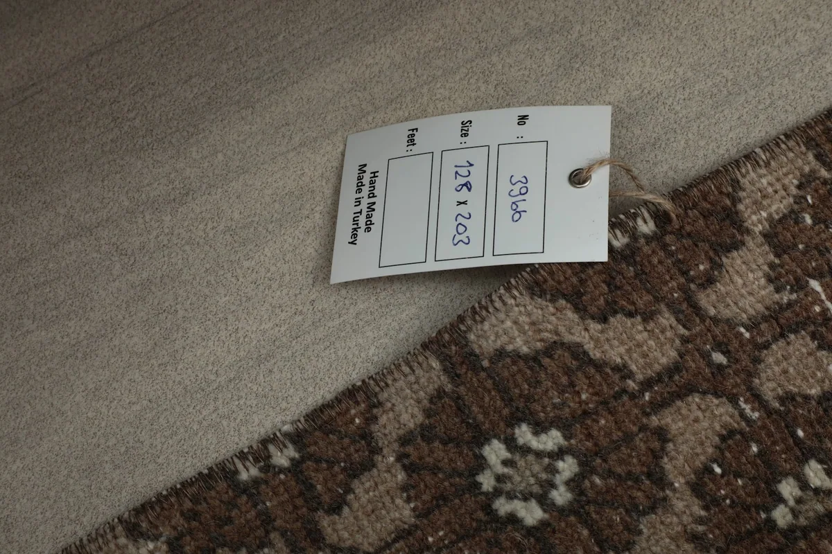 Product tag on the rug, confirming 'Hand Made in Turkey' and dimensions