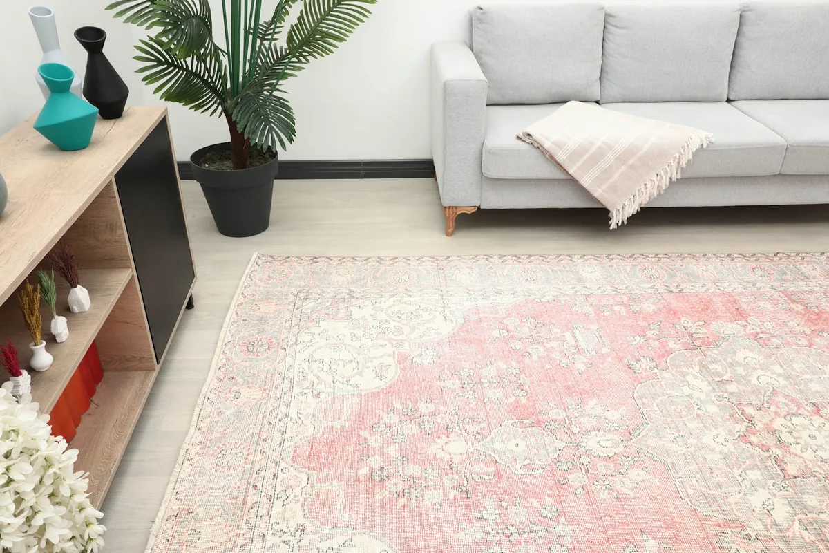 Another room view of the vintage rug, showing its placement relative to furniture and decor