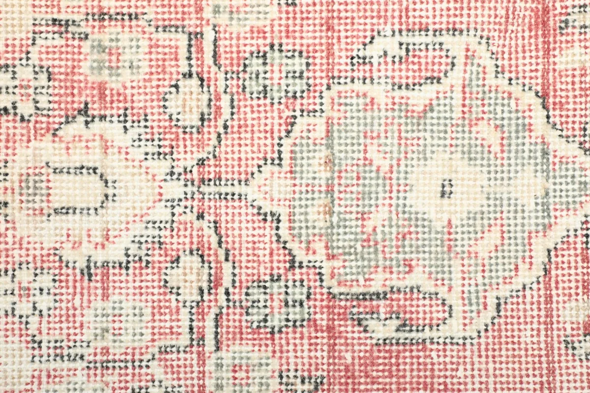 Close-up of the low wool pile, revealing the texture and subtle color variations of the rose field