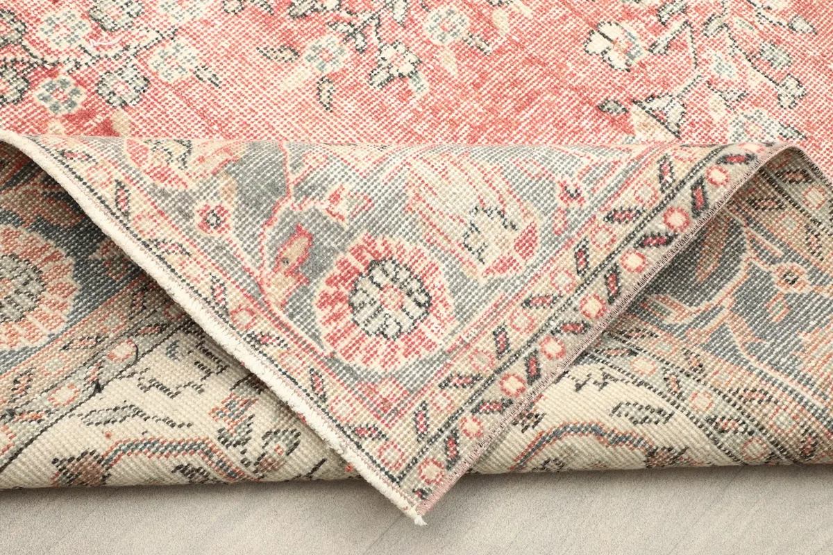 View of the rug's back, showing the hand-knotted construction and cotton foundation