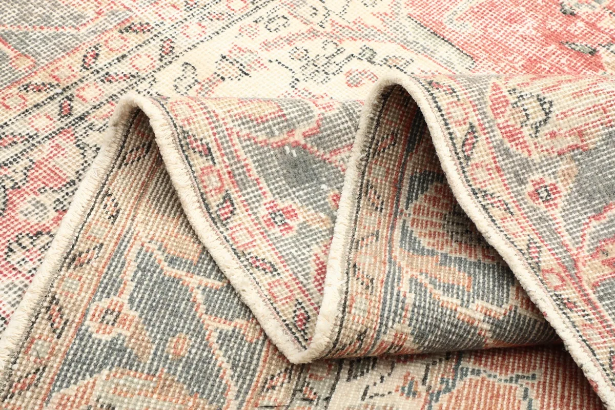 Folded section of the rug, illustrating its flexibility and the reverse side's construction