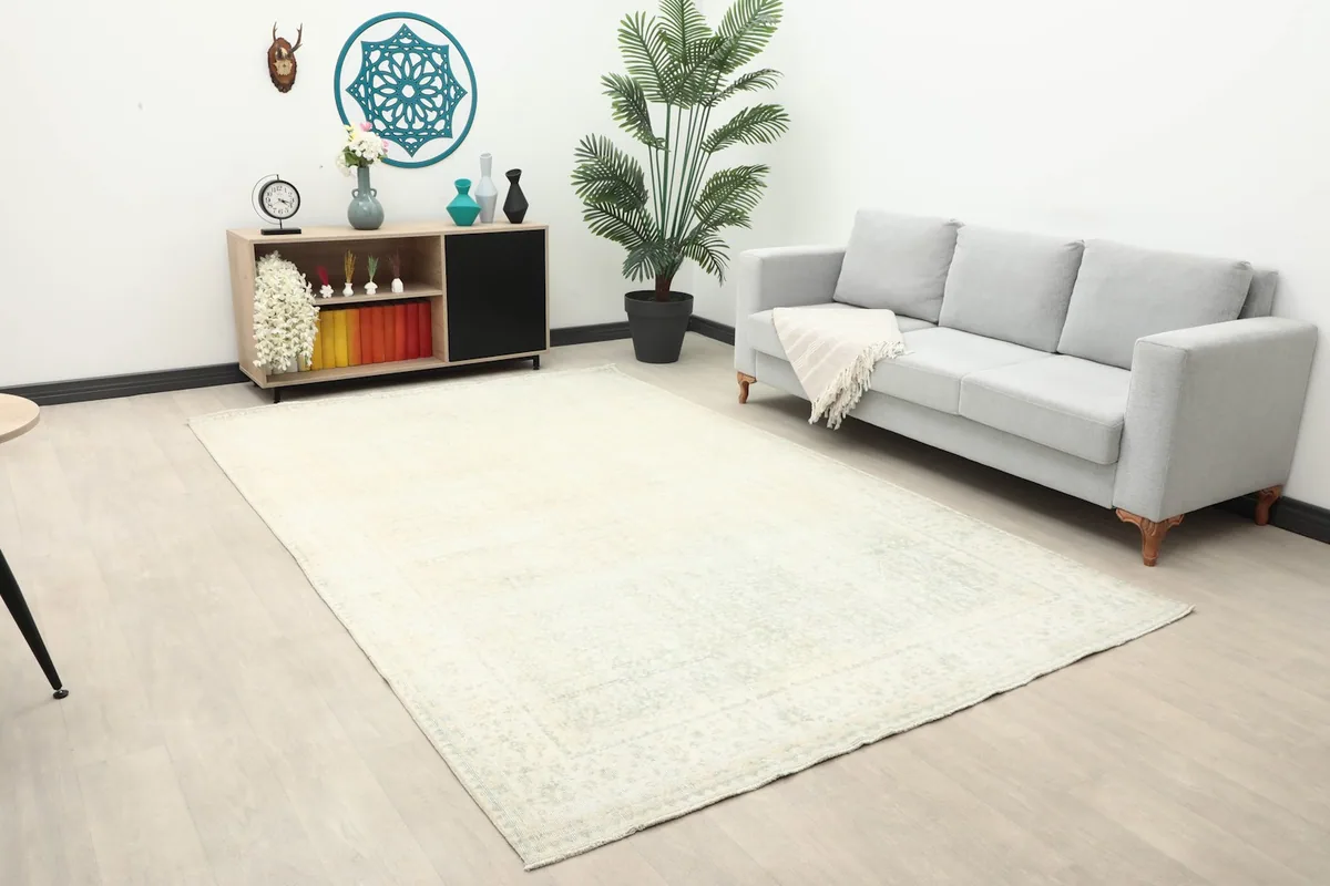 Wide view of the ivory geometric rug placed in a bright, contemporary living space