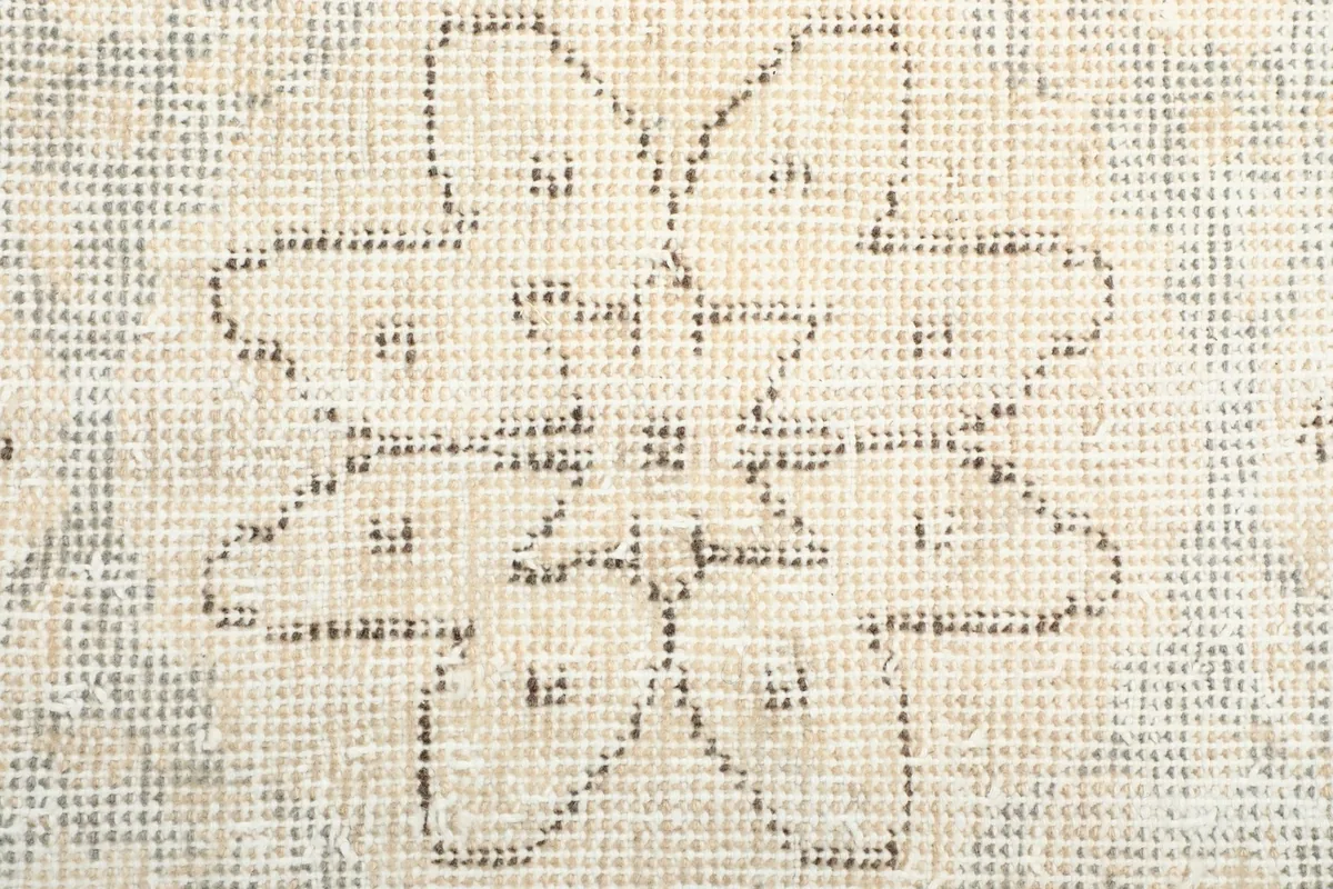 Close-up showing the low pile and hand-knotted texture of the vintage wool rug.