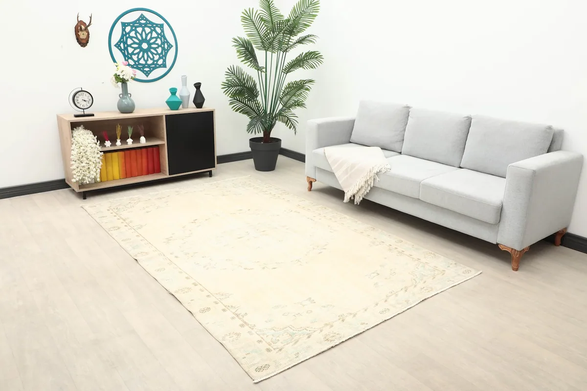 Angle view of the ivory rug in a living room, highlighting its placement and scale with a sofa