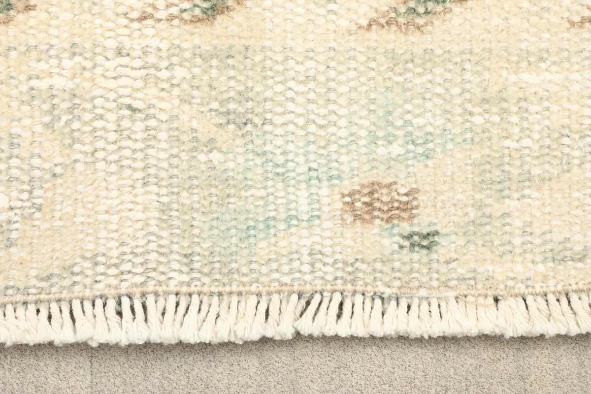Close-up of the rug's fringe and edge, showing the texture and weave