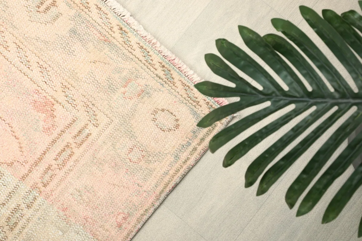 Close-up of a corner section highlighting the faded rose and blue tones in the border