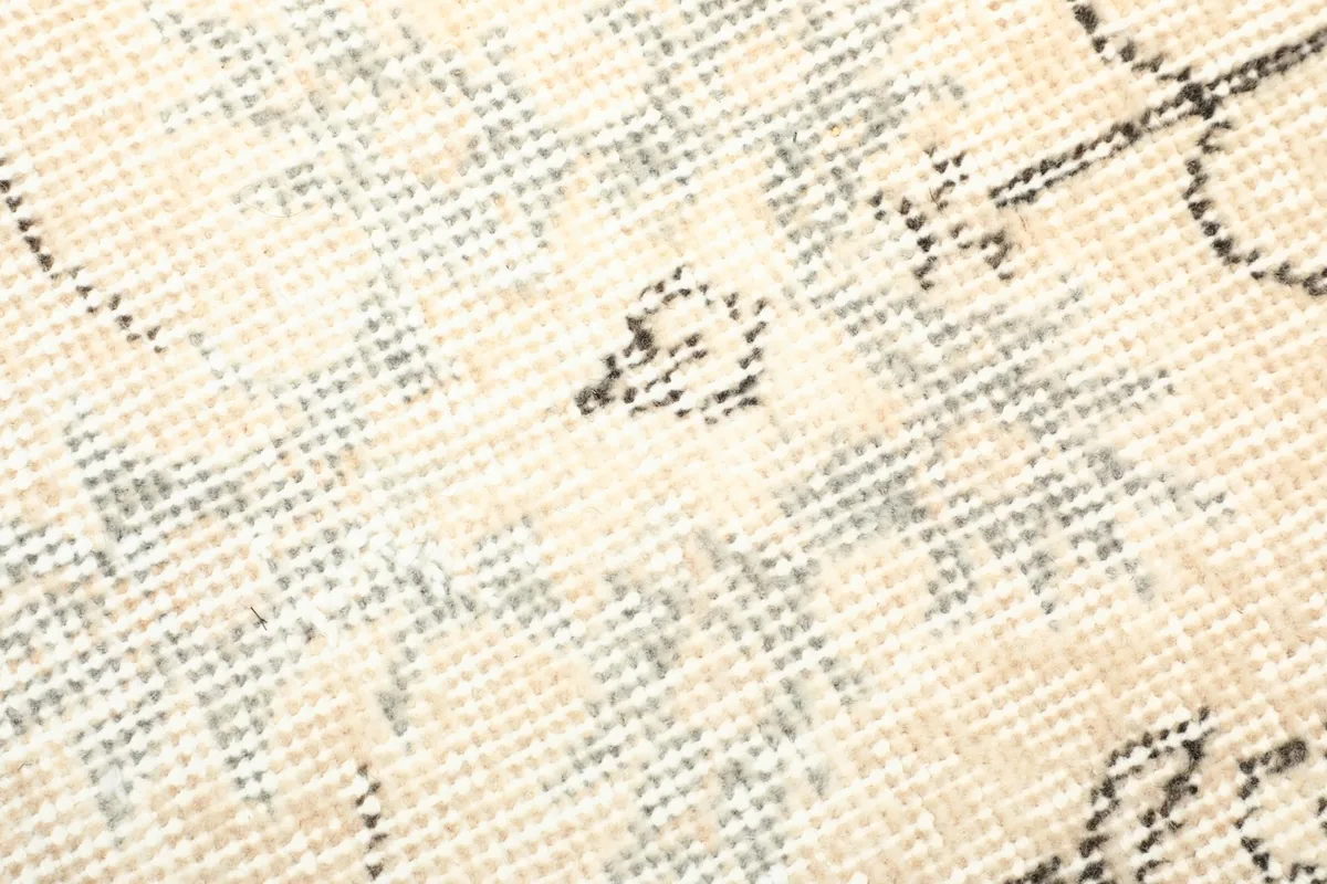 Texture close-up of the low wool pile, showing the distressed nature and subtle color variations