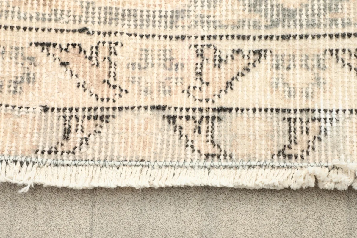 View of the rug's fringe and the reverse side of the hand-knotted cotton foundation