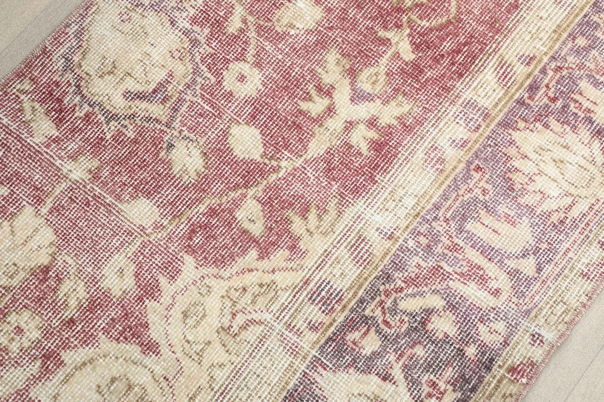 Close-up of the hand-knotted wool pile and the distinct color variation between sections.