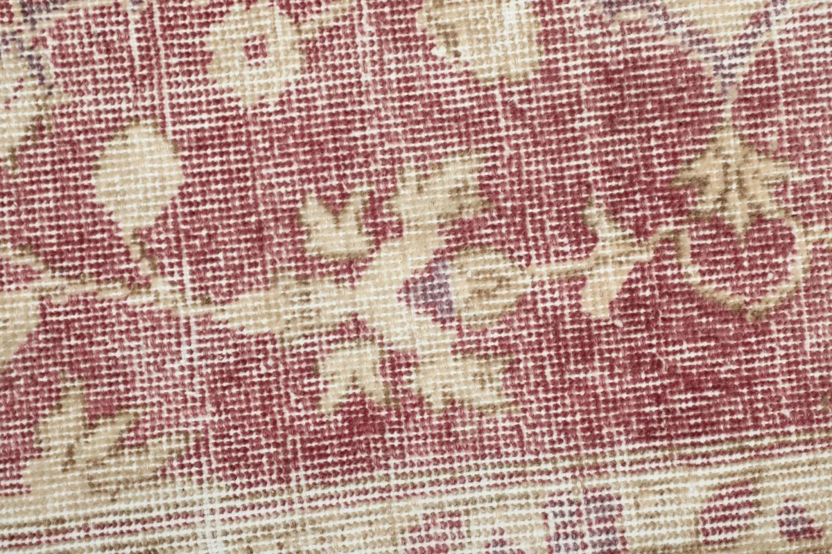 Texture close-up of the low wool pile, revealing the knotting and distressed look.