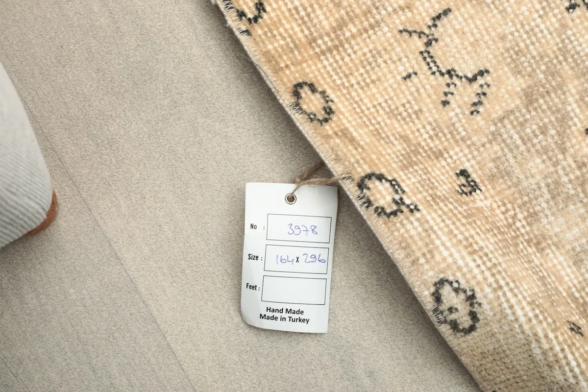 View of the rug's reverse side with a tag indicating its hand-made origin in Turkey.