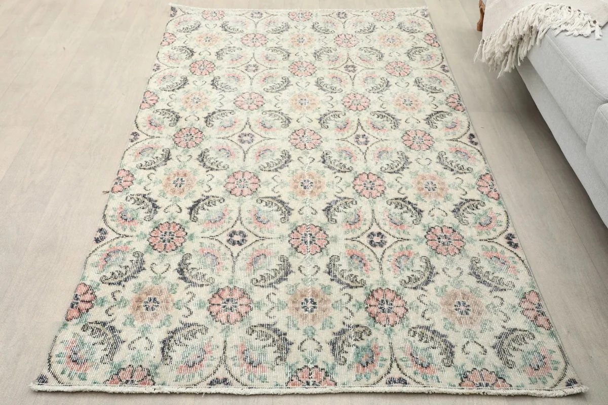 Overhead view of the small ivory rug showcasing its floral lattice pattern in a room setting