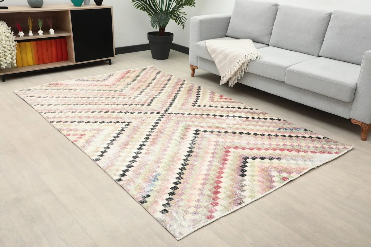 Angled view of the beige multicolor geometric rug in a modern living space