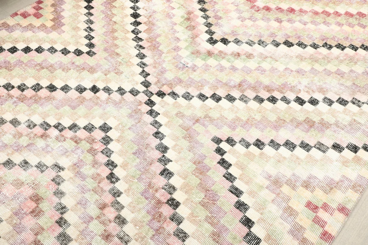 Detailed view of the geometric square pattern with beige, pink, green, and black colors