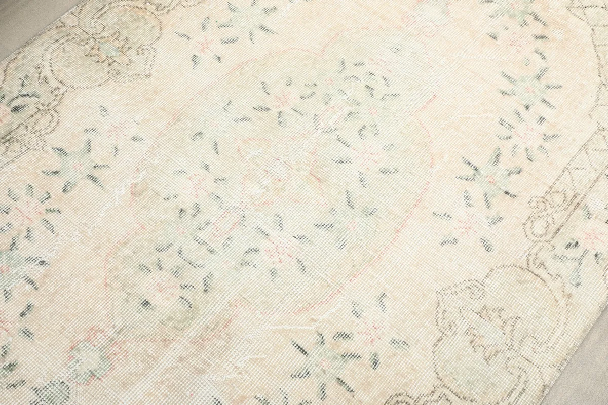 Close-up of the central field showcasing the delicate floral design and soft color variations.
