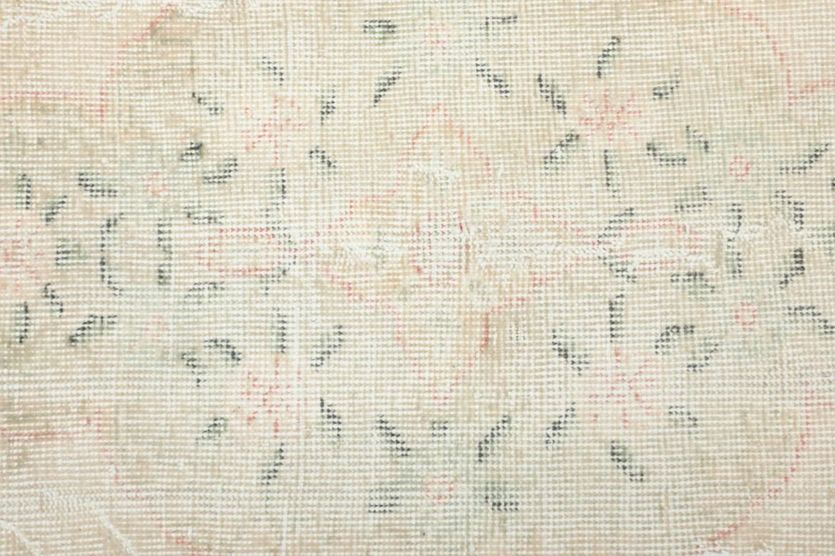 View of the back of the hand-knotted wool rug, revealing the cotton foundation.