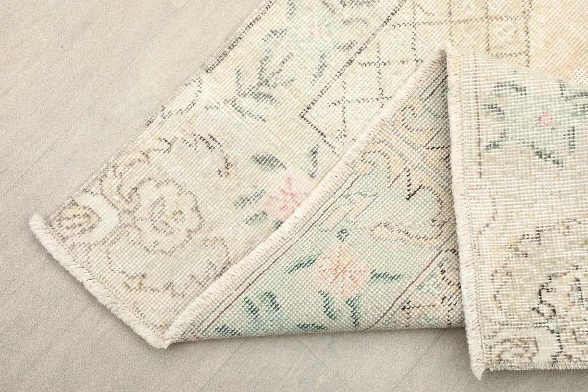 Folded corner of the rug, highlighting the structure and color of the design.