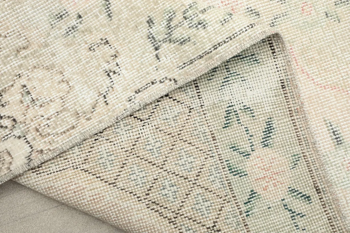 Another folded view showing the intricate weave and vintage patina of the rug.