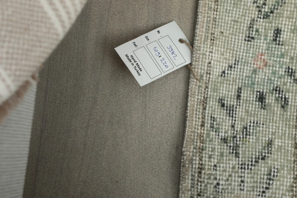 Product tag attached to the rug, indicating its origin and dimensions.