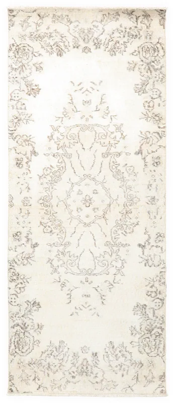 Full overhead view of the 2'7" x 6'5" ivory vintage Anatolian runner with faded floral patterns.