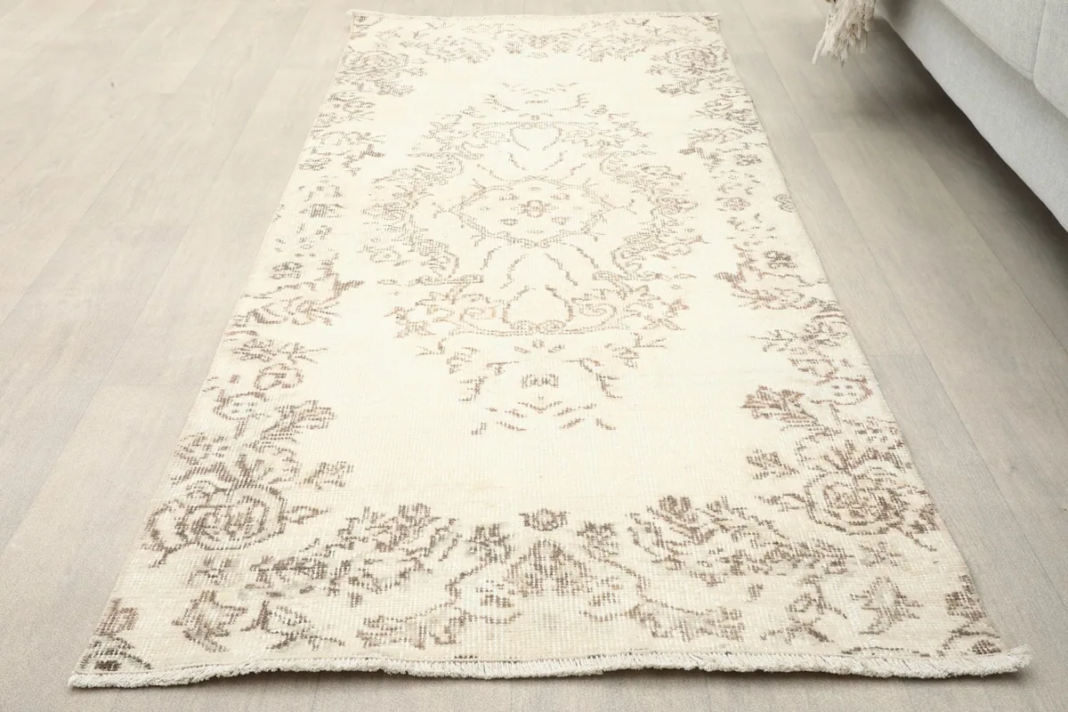 Slightly angled overhead view of the Anatolian runner showing its length and faded design.