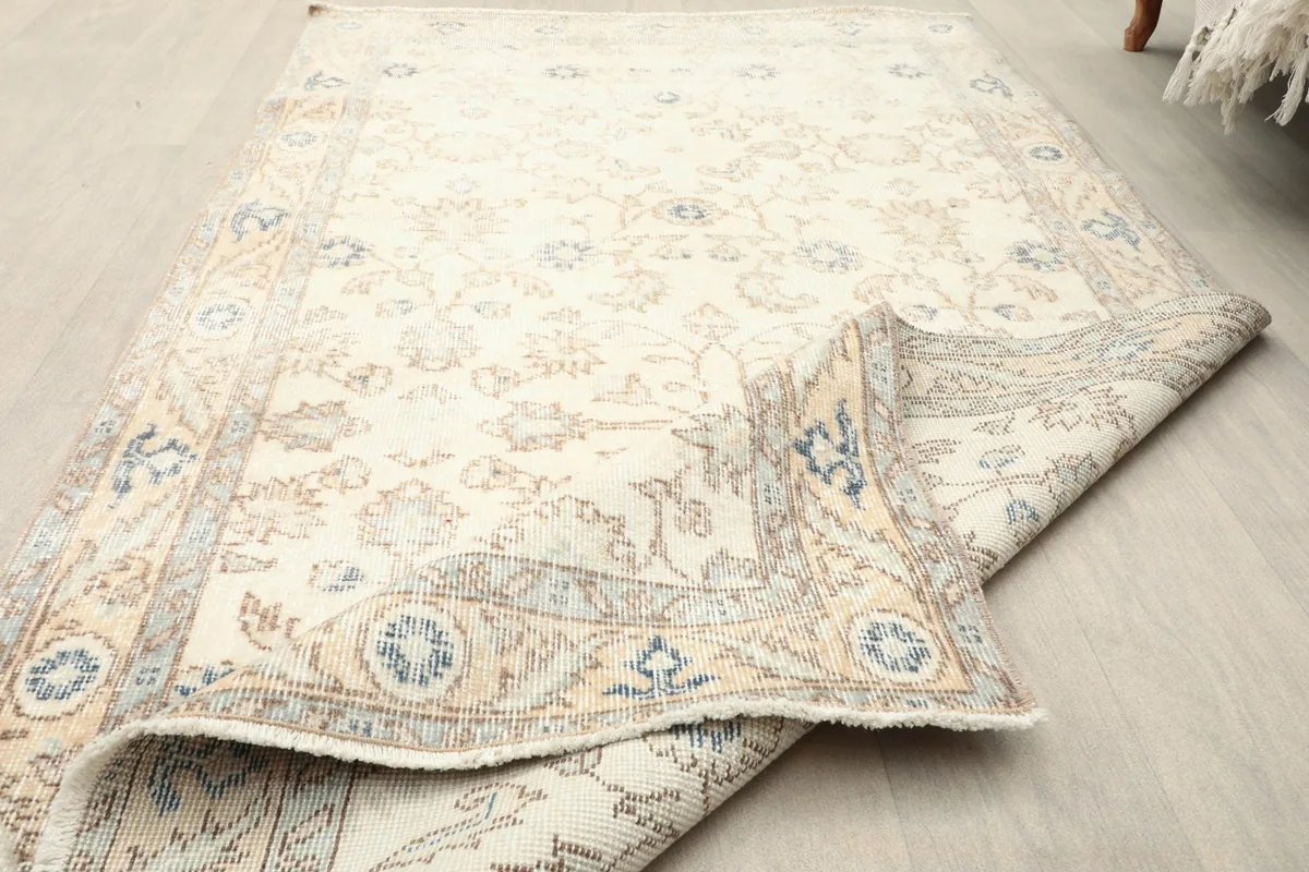 Angled view of the rug, partially folded, showcasing its overall appearance and texture.