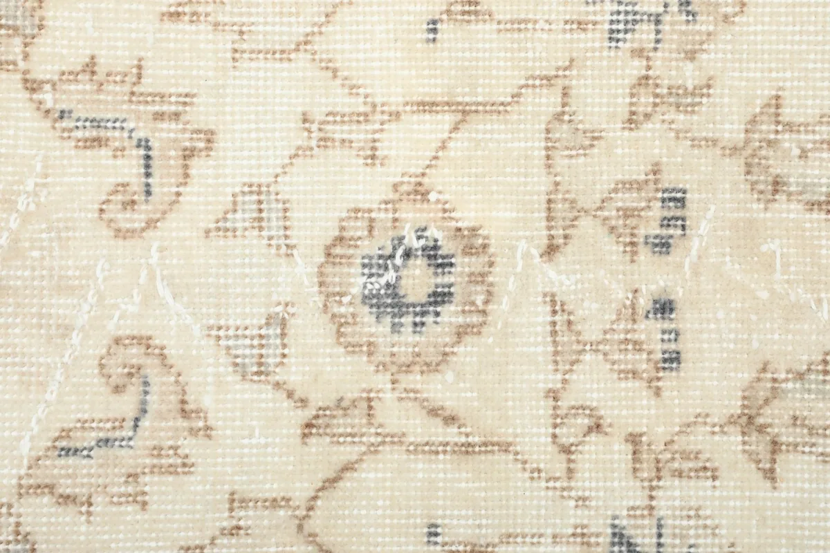 Close-up showing the low wool pile and the hand-knotted texture of the rug.