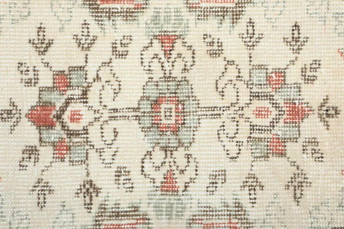 Close-up of the hand-knotted wool pile, showing individual knots and color variations in the pattern