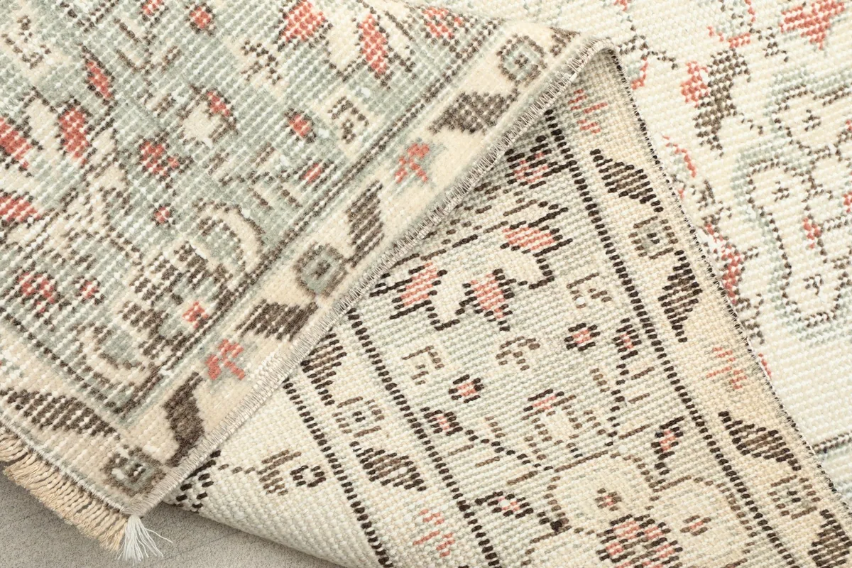View of the reverse side of the rug, showing the cotton foundation and hand-knotted construction