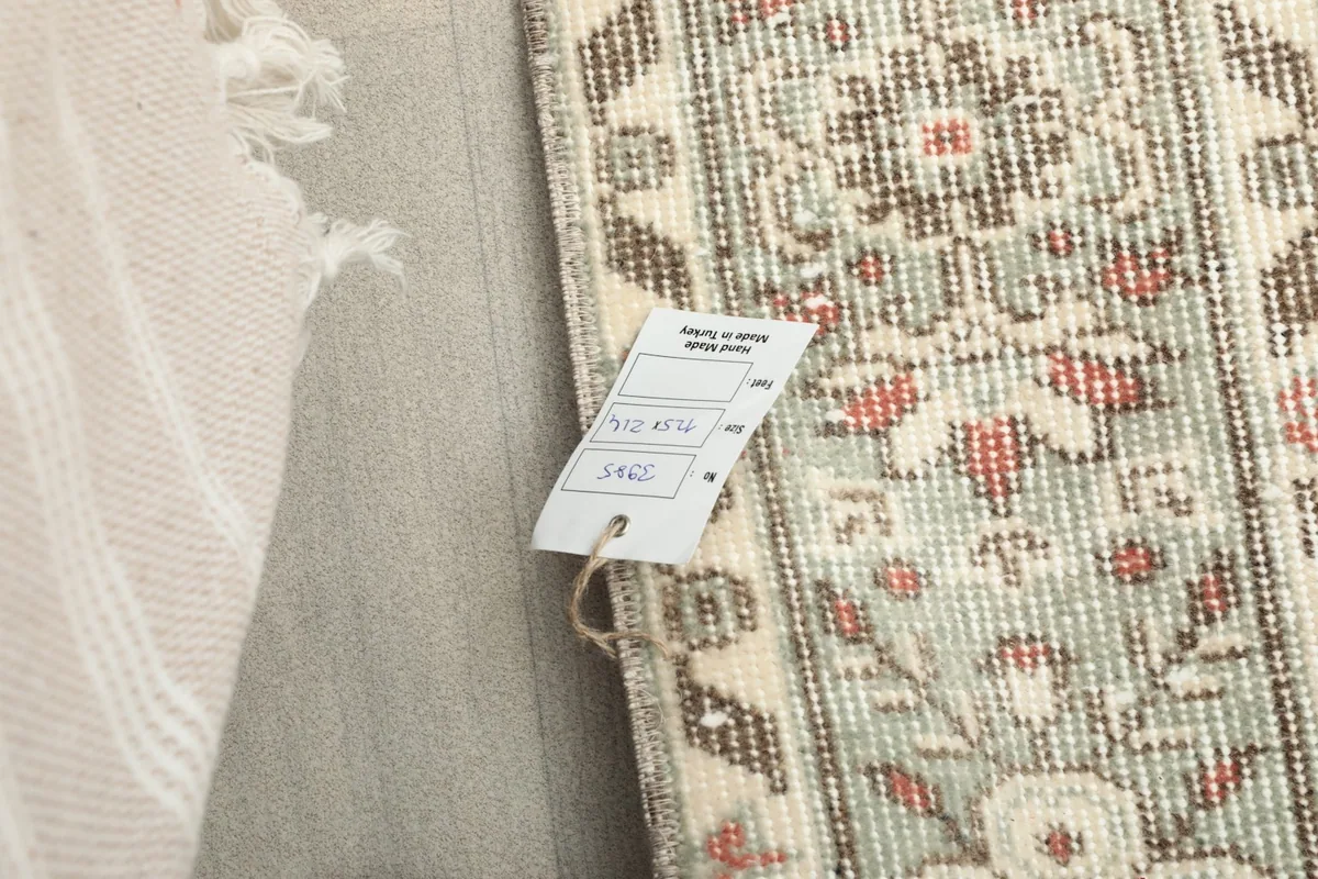 Close-up showing the small label attached to the rug's edge, indicating its origin and material